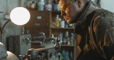 A Man Using a Lathe Machine