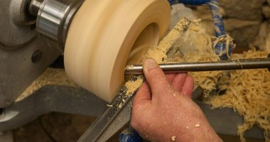 a man is working on a piece of wood