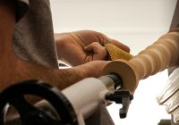 a close up of a person working on a lathe machine