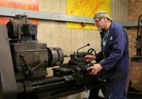 a man working on a machine in a factory