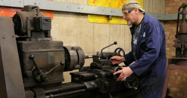 a man working on a machine in a factory